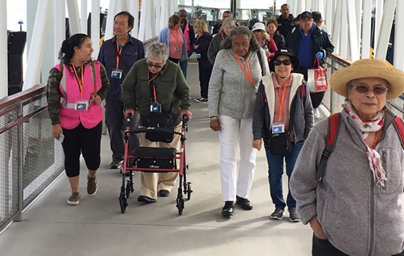 Older adults and companions walking together in WCCTC’s community travel photography